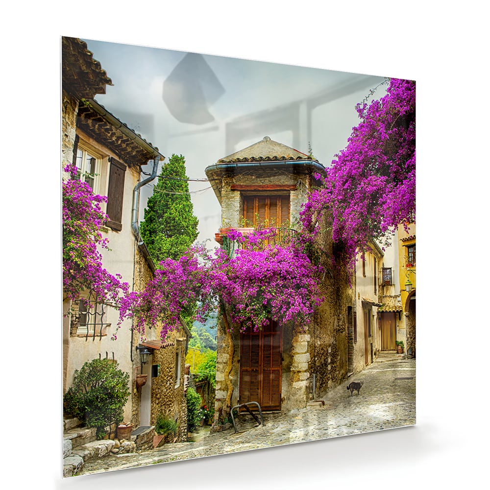 Glasbild mit stimmungsvoller Straßenansicht und violetten Blüten – Glasbild aus Sicherheitsglas, Größe 100x70