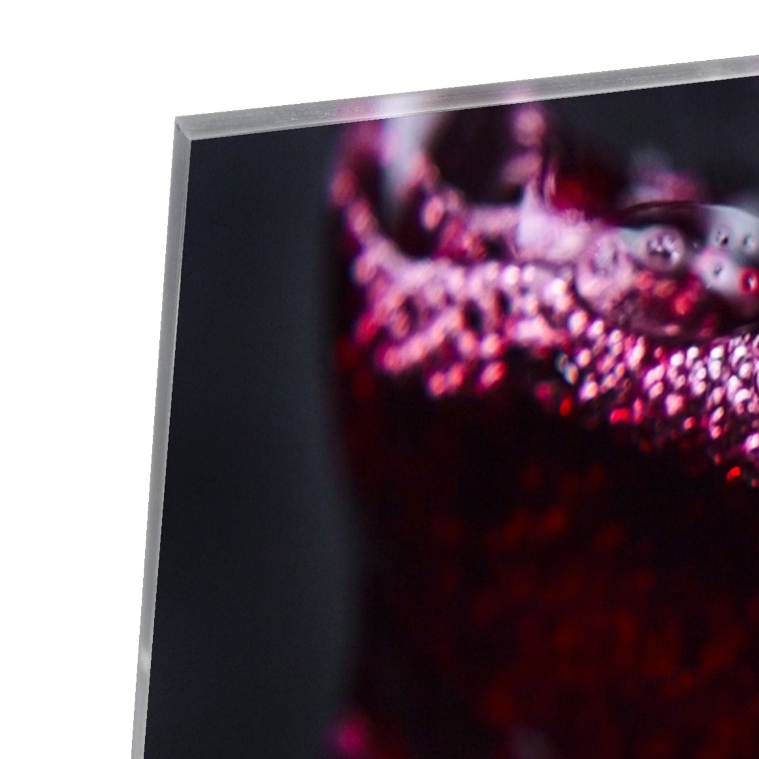 Glasbild – Farbiger Rotwein in einem Glas